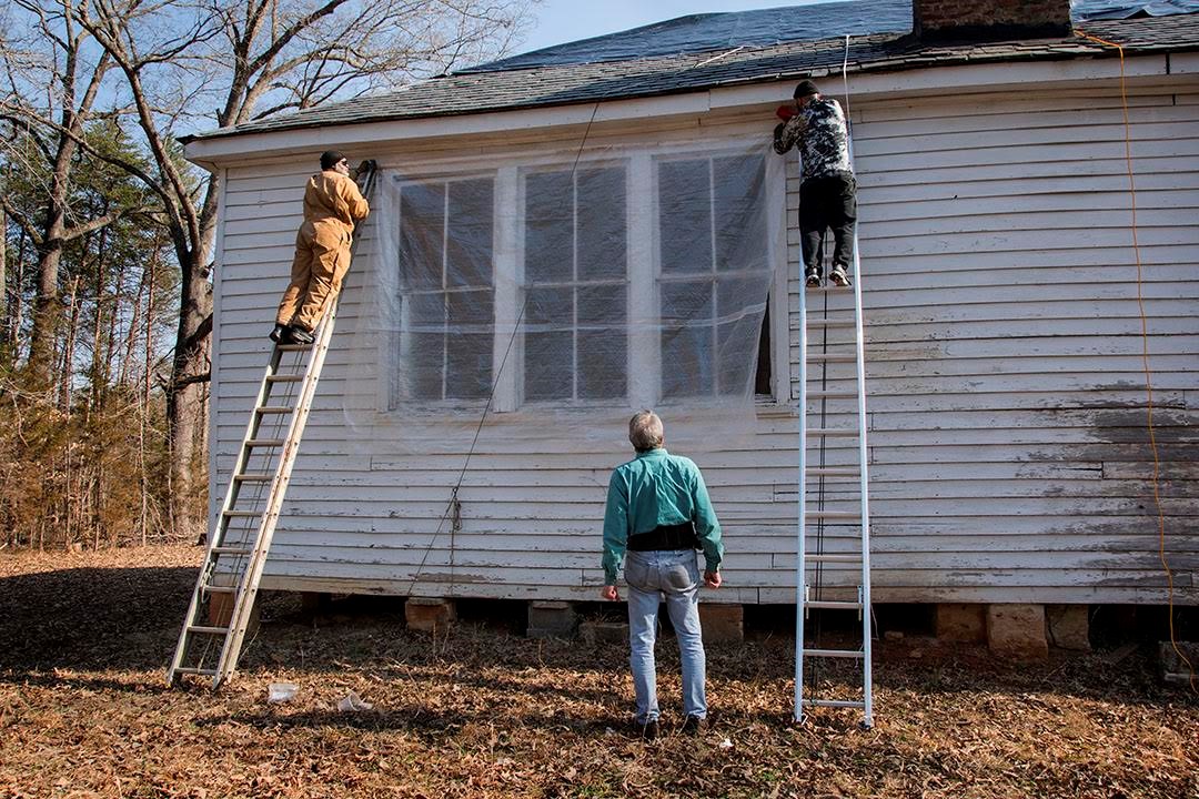 Former Pine Grove students and descendants came together on a 2022 workday to protect the school from water damage. An architect from UVA consulted on the project.